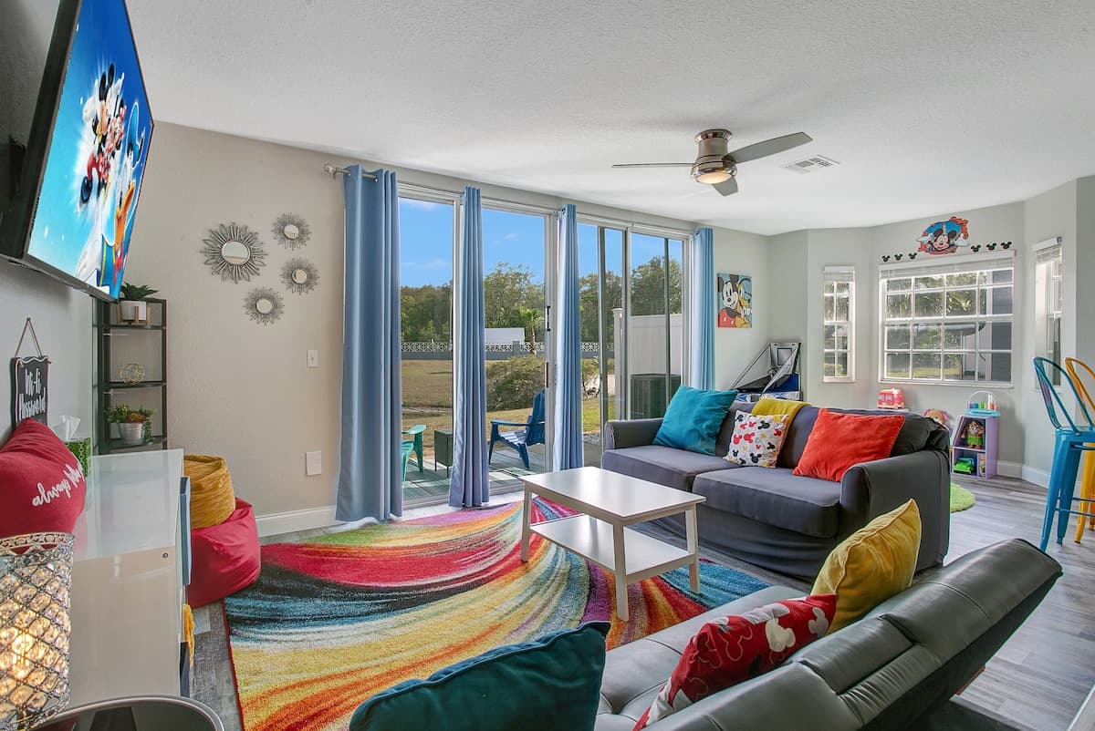 Coco Plum living room with a rainbow rug and sliding doors to the lake