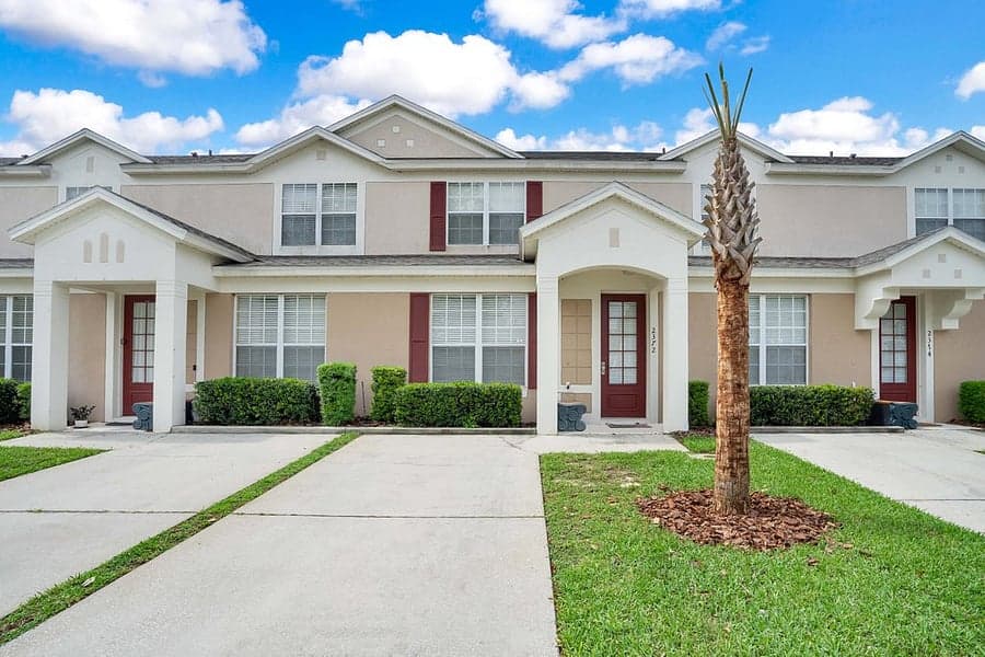 Silver Palm townhome exterior with a palm tree out front